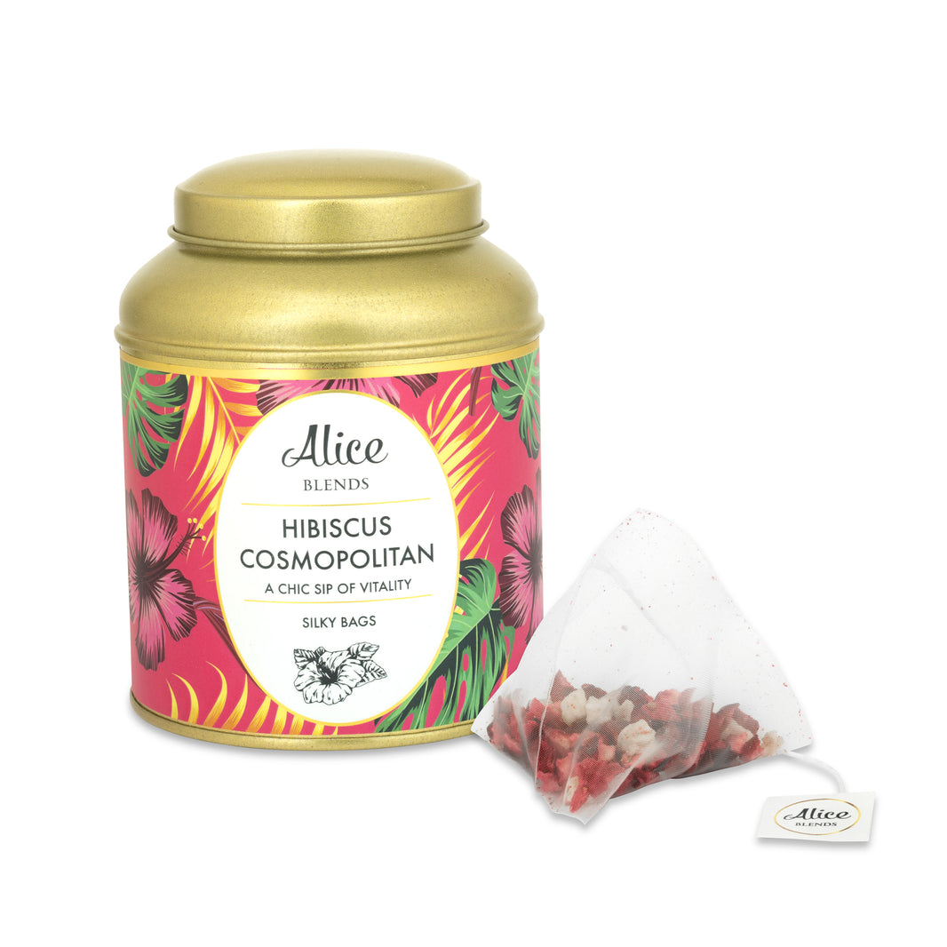 image Hibiscus Cosmopolitan herbal tea golden tin with pink floral label and silky tea bag.