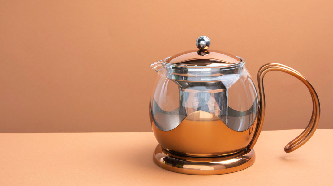 La Cafetière glass and copper tea infuser 2-cup teapot  on beige background